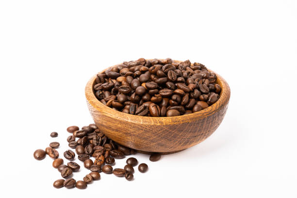 istock Bowl of coffee beans isolated on white background. 1514696213