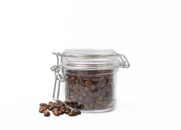 istock Coffee beans in glass jar isolated on white background 1514696227