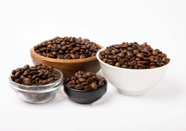 istock Bowl of coffee beans isolated on white background. 1514696596