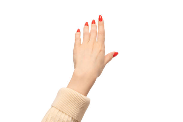 istock Woman hand with red nails holding something. 1514705349