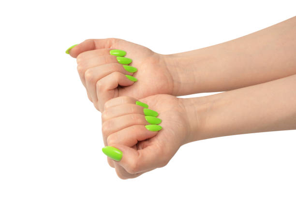 istock Hand of a woman with green naols hold some tiny or thin object. 1514706247