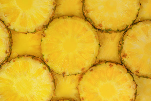 istock Pineapple juicy yellow slices as a background. 1514706424