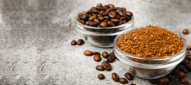 A cup of fragrant espresso coffee, instant coffee and coffee beans on a black stone background. Place for text. Space for copy text
