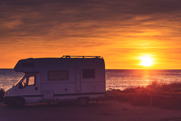 istock Camper car on beach at sunrise 1514724875