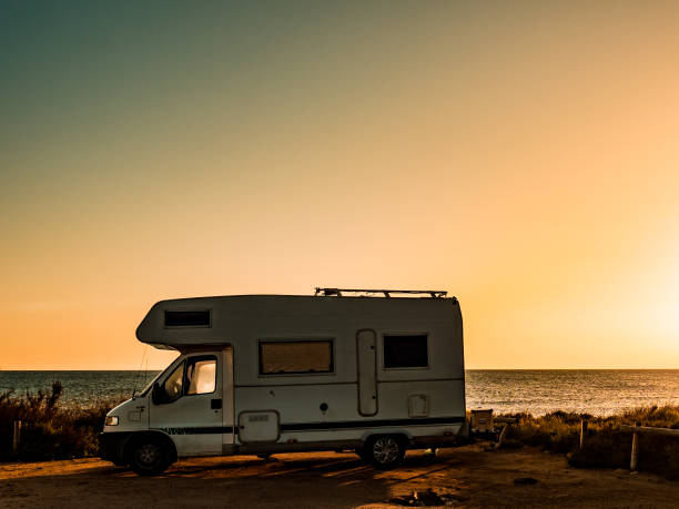 istock Camper car on beach sea shore 1514727783