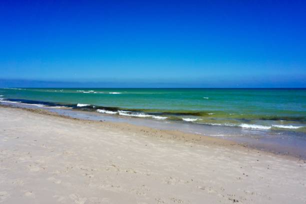 istock Sandy beach and blue sky. White sand and blue sky. A Danish beach on a sunny summer day. Scandinavian beaches in summer. 1514728015