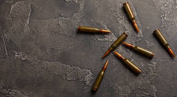 istock Bullets and ammo magazine with kolashnikov assault rifle on  texture marble.Composition with place for text.Rifle and carbine cartridges on wooden background.Military concept.Copy space 1514732536