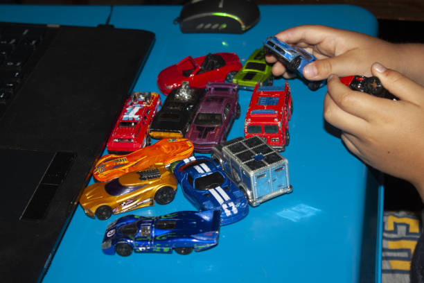 istock baby hands playing with cars 1514751270
