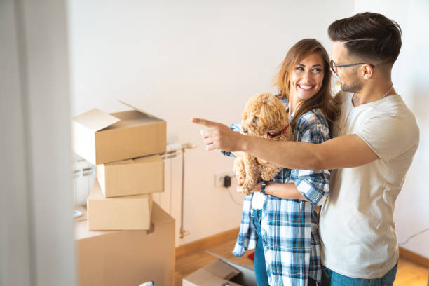 istock Young couple with a dog making plans for home improvement 1514752332