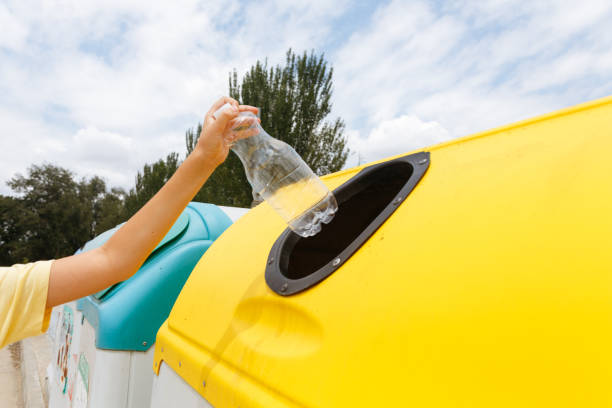 istock Close-up hand throwing out a plastic bottle in a trash can 1514757262