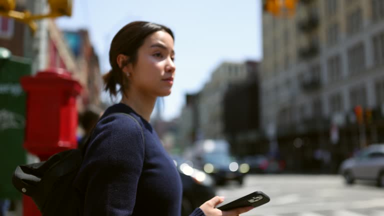 Asian Female Student Navigating Soho and West Village with Mobile Phone