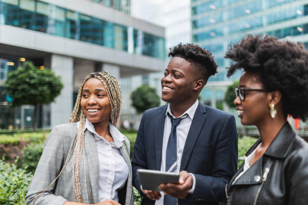 istock Young adult black colleagues discussing new project using digital tablet 1514779693