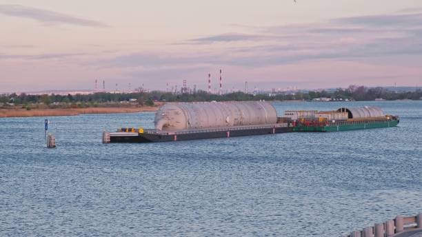 istock Huge Industrial Cylindrical Tank Transported on River Barge 1514788127