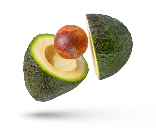 istock Falling avocado divided into parts isolated on white background. Avocado with a stone is cut into pieces that fall in different directions. Avocado slices with peel on a white background. 1514798525