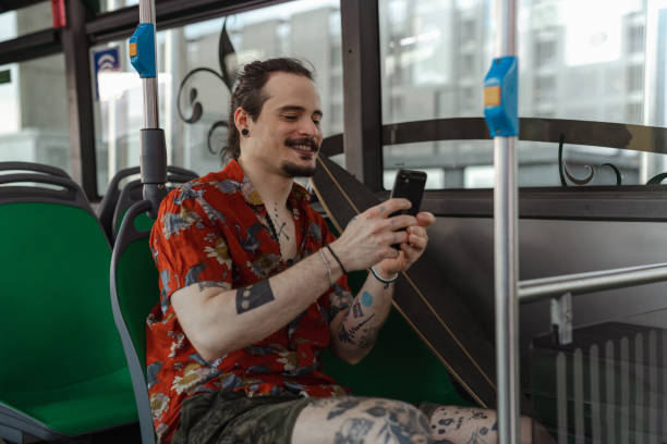 istock Young man texting on a cellphone in a public bus 1514822264