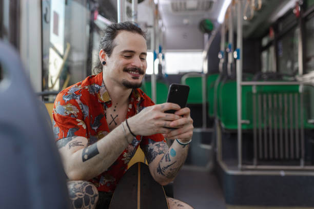 istock A young man using his mobile phone while sitting on the bus 1514822279