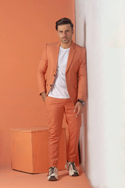 istock Male model posing in orange suit 1514823168