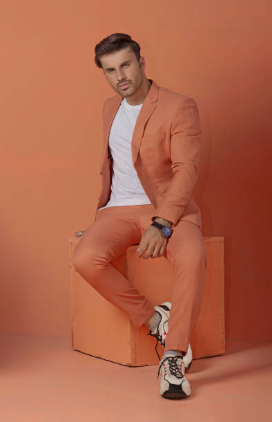 istock Male model posing in orange suit 1514823306