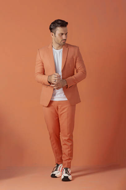 Male model posing in orange suit