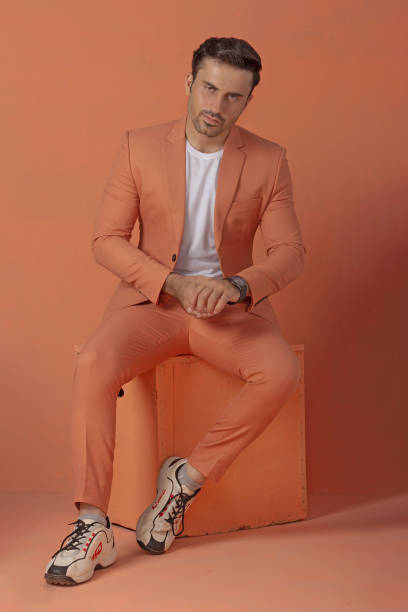 istock Male model posing in orange suit 1514823811