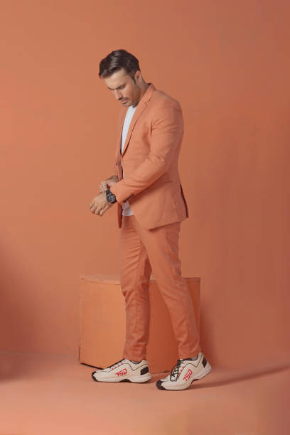 istock Male model posing in orange suit 1514823832