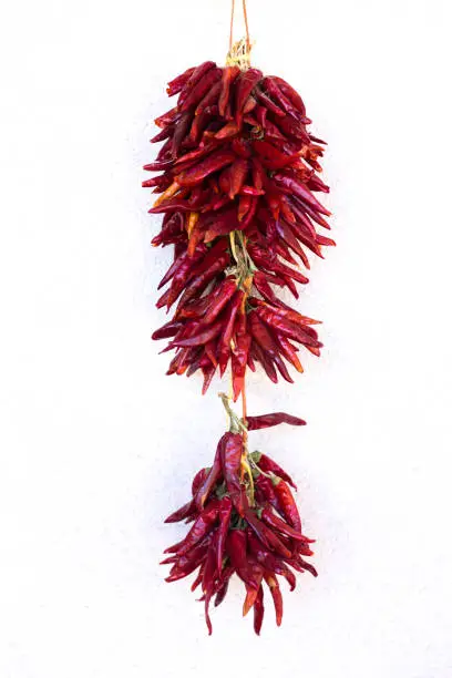 Photo of New Mexico: Chili Pepper Ristra on White Wall, Copy Space
