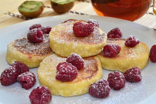 istock Curd pancakes sprinkled with powder and fresh raspberries 1514870645