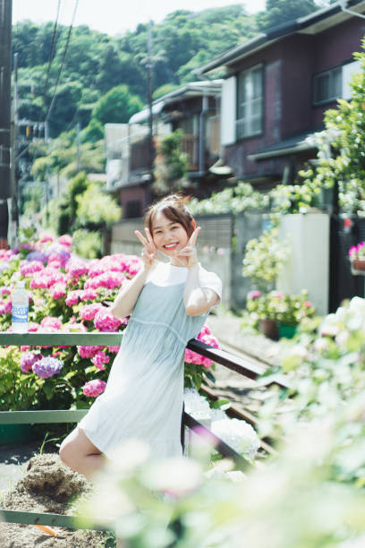 Asian beautiful woman traveling to Japan with beautiful hydrangea.