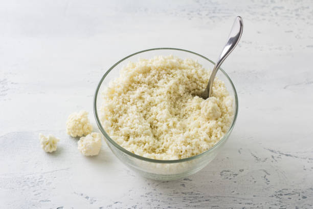 istock Shredded cauliflower, cauliflower rice or cauliflower couscous on a light blue table. Cooking delicious vegan healthy food 1514874158