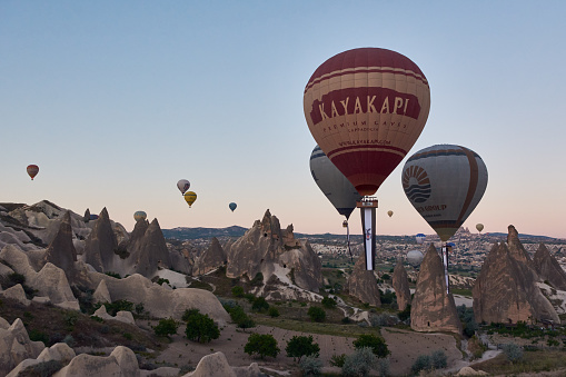CAPPADOCIA, TURKEY - MAY 18, 2021: Hot-air ballons flying above Cappadocia at dawn