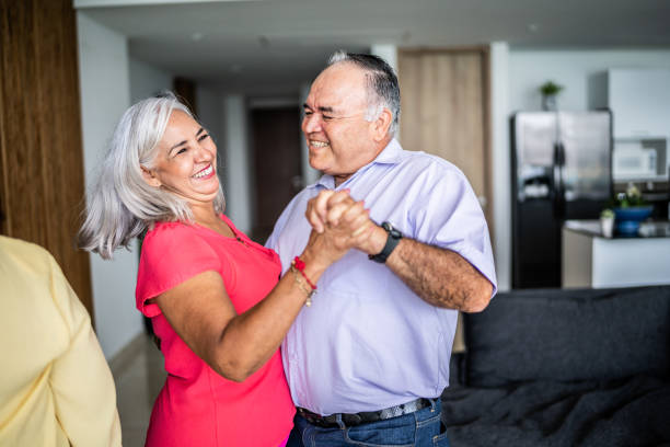 istock Senior couple dancing close together at home 1514908111