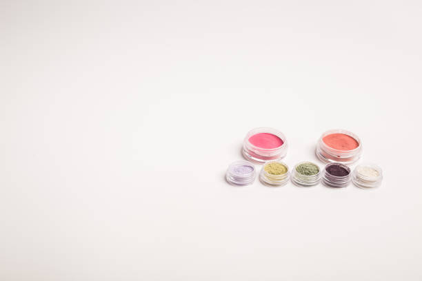 Many colorful natural mineral eyeshadows isolated on white