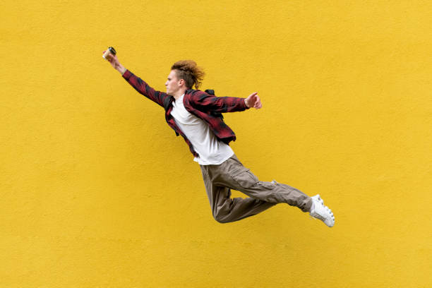 istock young guy student with backpack and coffee flies forward and rushes to study, energetic man jumps 1514980619