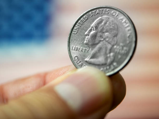 istock Quarter Dollar Coin in Hand 1515091010