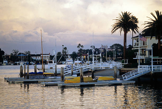Docks on Balboa Peninsula Docks on the Balboa Peninsula in Newport Beach, California, with dramatic clouds in the distance. hearkencreative stock pictures, royalty-free photos & images