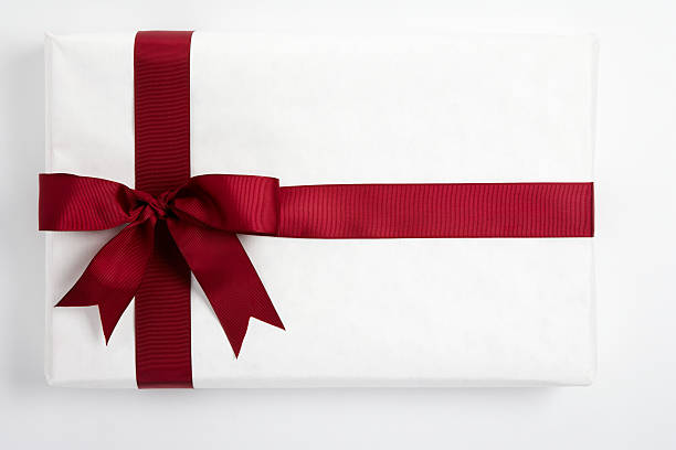 Red ribbon bow on white gift stock photo