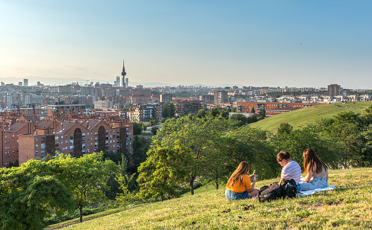 Madrid, Spain - June 23, 2023: People waiting for the sunset and enjoying the Madrid skyline over the hills of Vallecas, Madrid.