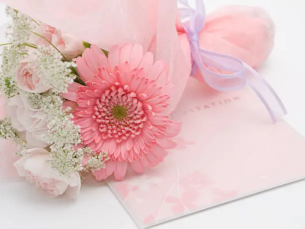 The invitation of the wedding, and flower arrangement.