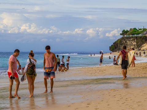 Bali, Indonesia - February 12, 2023: People on Dreamland Beach at sunset.
