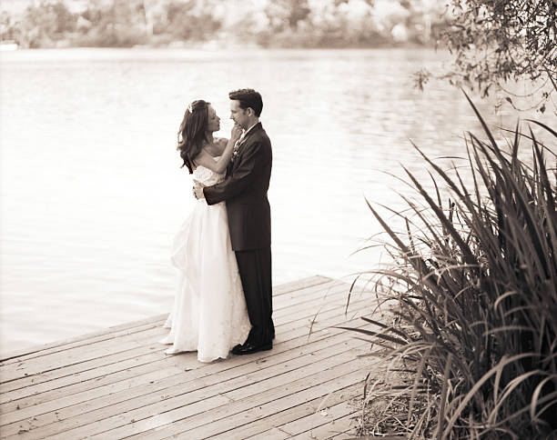 istock Interracial Wedding couple embracing on a dock 151512232