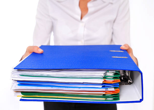 istock Blue Binder Presented by am Out-of-focus Business Woman 151512708