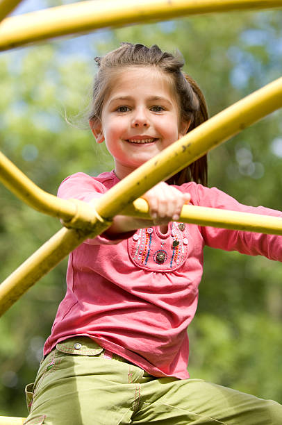 istock Happy young girl sitting on climbing frame 151512851