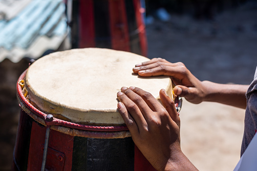 Hands of a musician standing still on a Brazilian atabaque. Acupe, Santo Amaro, Bahia.