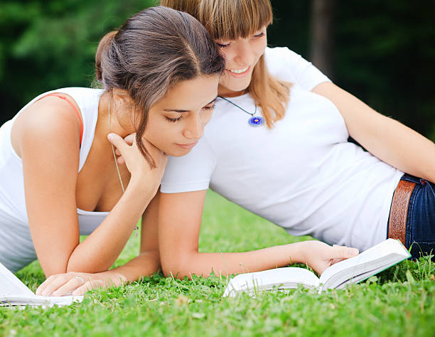 istock Two girls reading a book 151513448