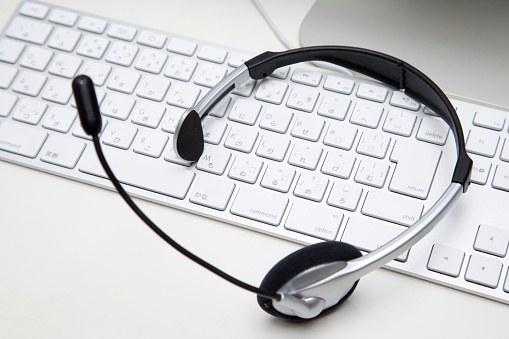 BUSINESS IMAGE-a headset on a white keyboard