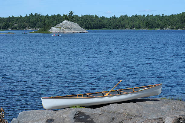 istock White canoe on a rocky shore 151515164