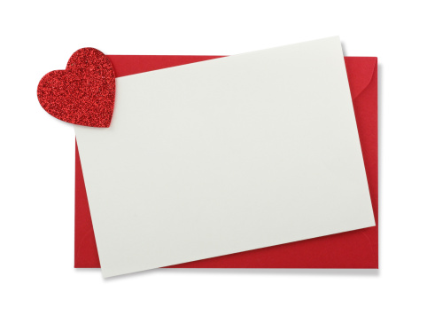 Red paper envelope with white card and heart isolated on white background