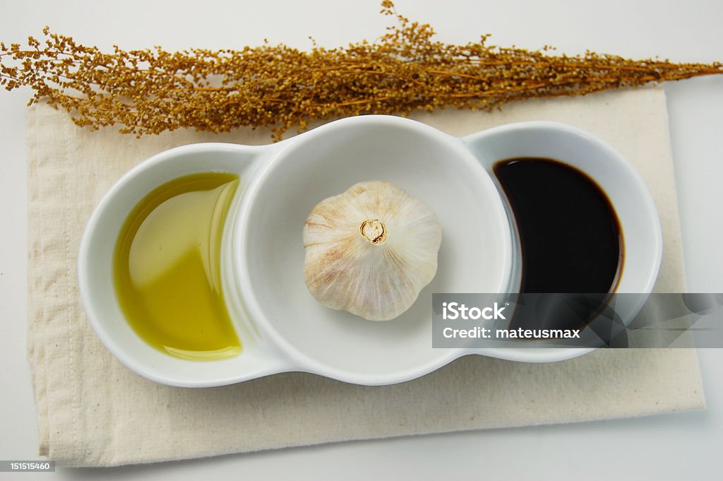 Garlic in a dipping bowl garlic clove in a dipping bowl with olive oil and vinegar Balsamic Vinegar Stock Photo