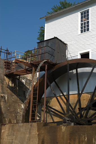 a grist mill wheel and spewing water