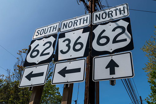 Directional road signs for State Routes 62 and 36 in Tionesta, Pennsylvania, USA on a sunny spring day